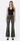 front view of model wearing olive green jeans with black tank top with a white background
