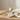 Candle lifestyle image with warm neutral styling
