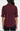 A woman viewed from the back wearing a burgundy blouse with three-quarter ruffled sleeves and a curved hem, paired with black pants against a light gray studio background.