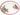 An oval white serving platter decorated with a red cardinal perched on a pine branch on the right and a holly wreath with pinecones and a red bow on the left, finished with a red rim.