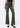 front view of olive green floral jeans on model with white backdrop