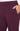 Close-up of a person wearing dark plum pants, showing the side pocket with a hand resting inside it.