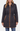 A woman wearing a black diamond-quilted coat with tan contrast trim, a tan zipper, and a tan drawstring waist, paired with blue jeans against a plain white studio background.