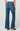 A person shown from the back wearing blue wide-leg jeans with a straight-to-flared leg and cuffed hems
