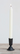 black taper holder on table with white candle
