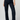 A model wearing a pair of dark navy blue straight-leg jeans, paired with a black top and black flats, standing against a light gray studio background.