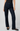 A model wearing a pair of dark navy blue straight-leg jeans, paired with a black top and black flats, standing against a light gray studio background.