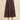 A dark brown tiered A-line midi skirt worn with a white top and dark brown slide sandals, shown against a solid beige background.