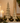 showing gold resin fir tree set on mantle for holiday decor