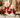 showing the pair of white resin candle holder with red bow on mantle
