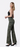 Side view of model wearing olive green floral jeans with white backdrop
