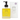 A bottle of Whispering Willow Natural Body Oil Lavender next to its white packaging box, both featuring a black pump and a yellow label, on a white background.