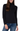 A woman wearing a black long-sleeve mock neck turtleneck sweater and blue jeans, shown from the waist up against a plain white background.