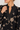 Collar view of this black floral shirt on model