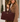 A woman in a camel coat carries a large burgundy suede tote bag with gold hardware and the brand name 'KATHY LEONARD' printed near the bottom.
