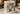 A cylindrical tin candle from Pine Southern Puzzle Co. featuring a festive holiday donut puzzle design on the label, set on a marble surface with blurred Christmas decorations in the background.